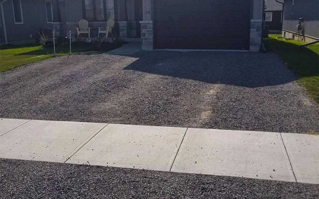 gravel driveway in front of residential home